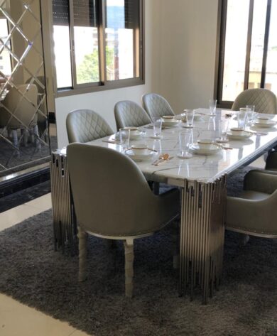 Dining Table with decorated stainless frame next to a decorated mirror on the wall