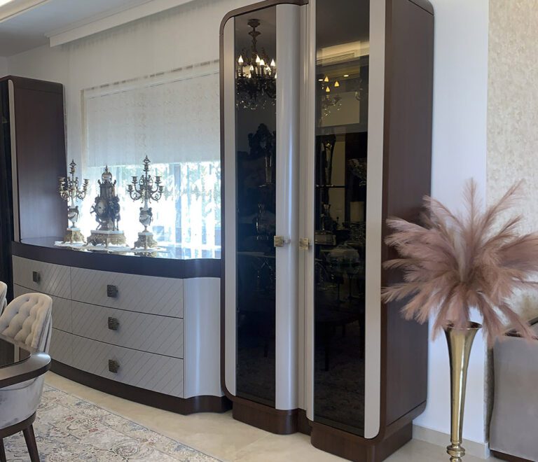 A vieww of the custom made sideboard and vitrine that houses antique china