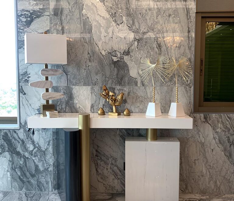 Marble and metal console with eye-catching decor pieces on top