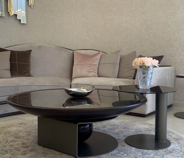 A custom made curved wooden and steel center table that pairs well with the neoclassic curved sofa