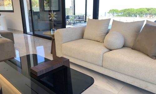 Customized white sofa with the pool in the background